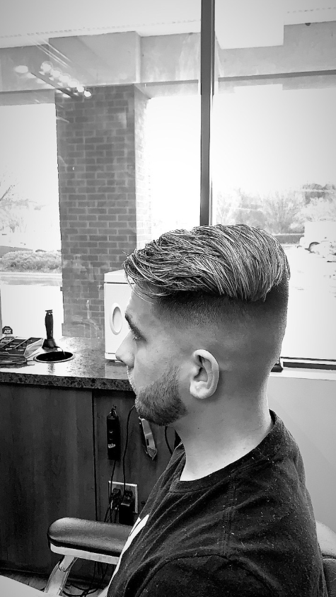 man in barbers chair getting hair cut