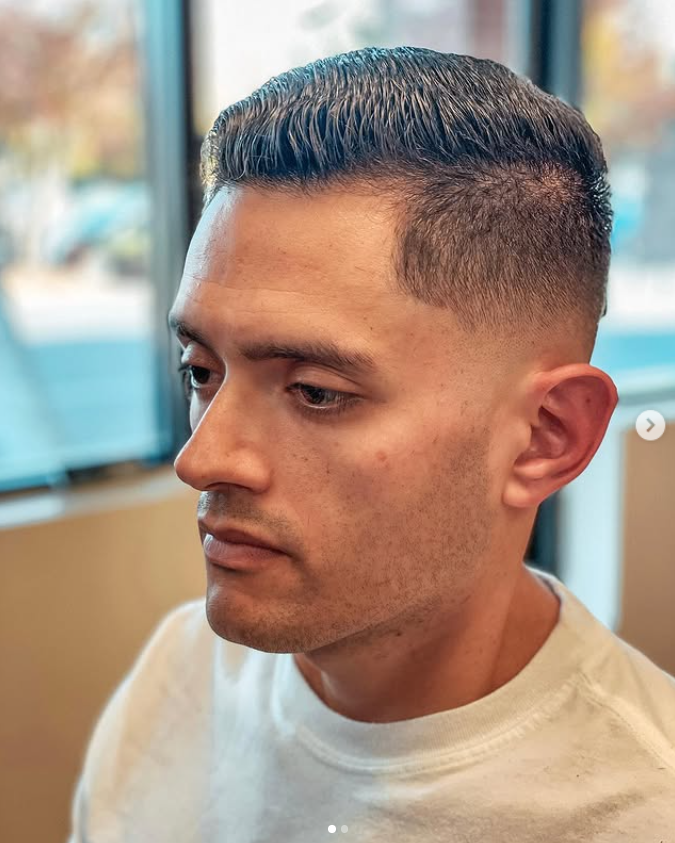 man in barbers chair getting hair cut