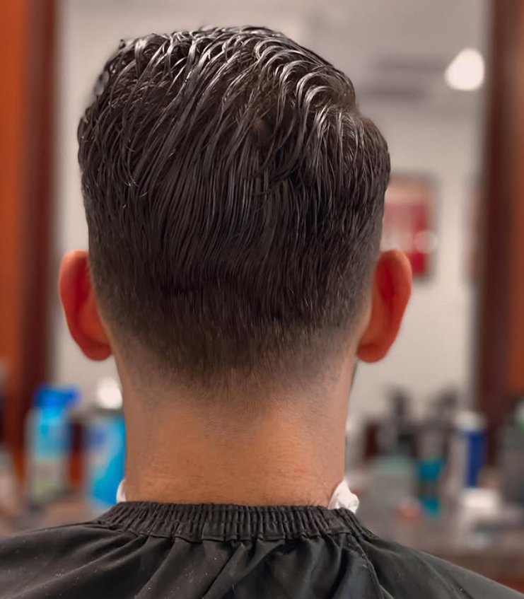 man in barbers chair getting hair cut