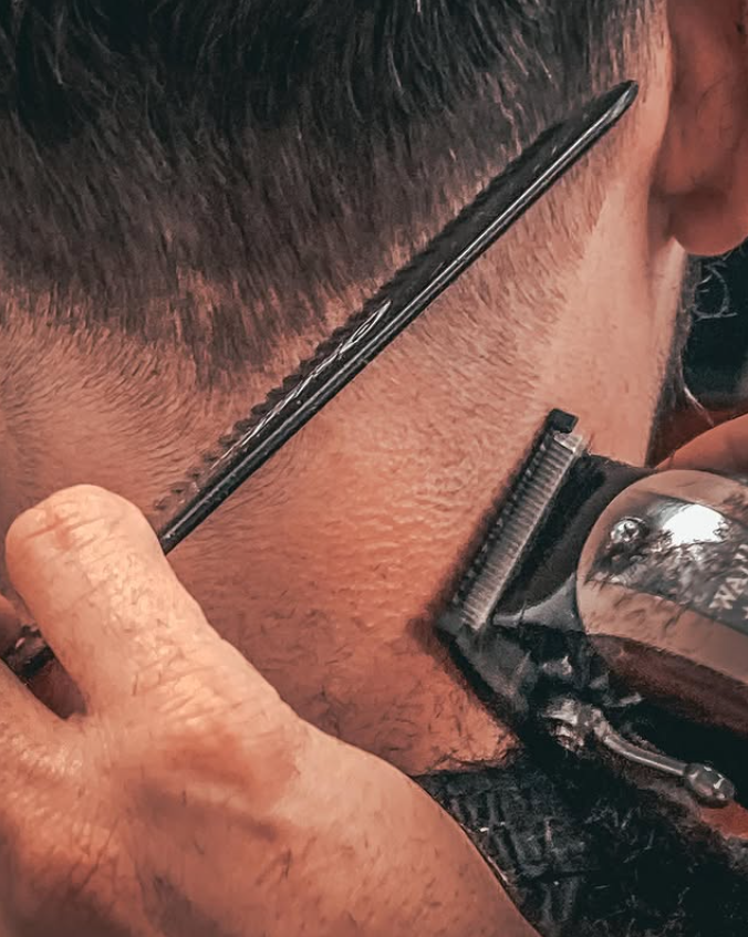 man in barbers chair getting hair cut